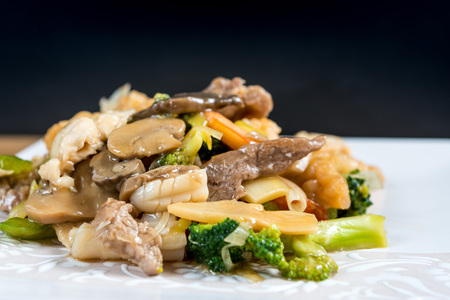 wok fried seafood stir fry with sweet peppers and chinese vegetablesの写真素材