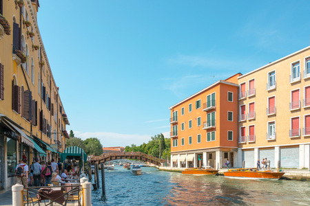 VENICE,ITALY-March 26, 2016.Tourists on water street with Gondola in Venice on May 26,2016. its entirety is listed as a World Heritage Site, along with its lagoon.May 26 VENICE,ITALYのeditorial素材