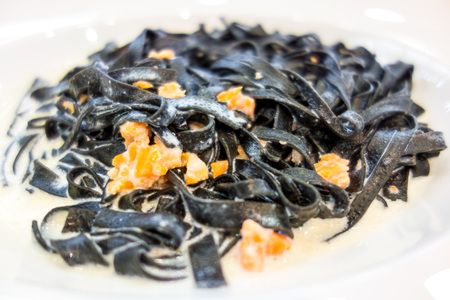 tasty pasta with salmon on a the tableの写真素材