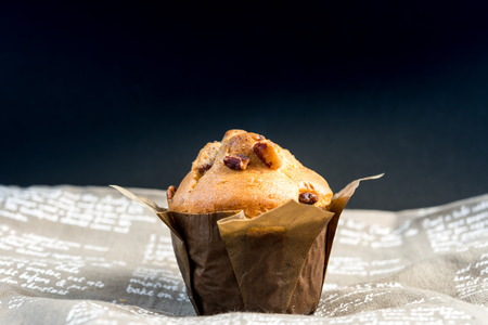 Homemade muffins in paper on napkinの写真素材