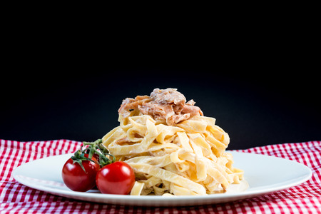 tasty pasta with salmon on a the tableの写真素材