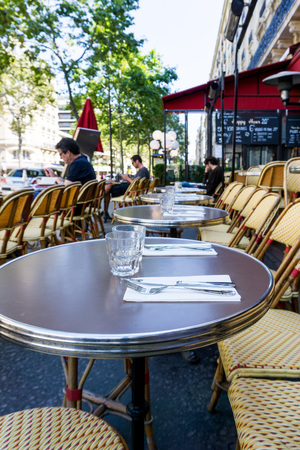 Street view of a coffee terrace with tables and chairs in europeの写真素材