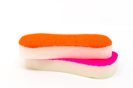 closeup cleaning sponge over white backgroundの写真素材