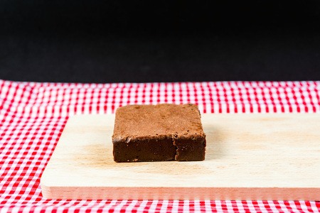 Chocolate Brownie cake on a dark plateの写真素材