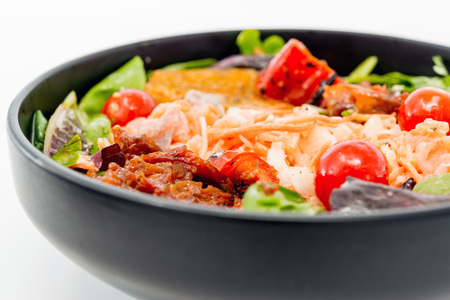 Delicious fresh salad with tomatoes, lettuce, eggplant, zucchini, cheese, parma ham and olive oil.の写真素材