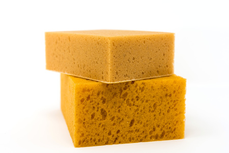 closeup cleaning sponge over white backgroundの写真素材