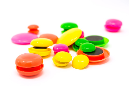 colored round magnets isolated on white backgroundの写真素材