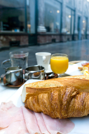 Breakfast with coffee and croissants on tableの写真素材