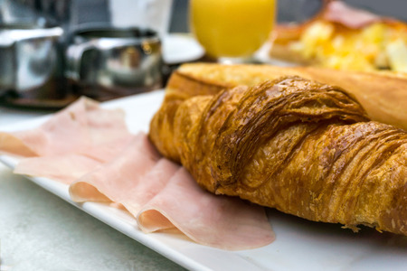 Breakfast with coffee and croissants on tableの写真素材