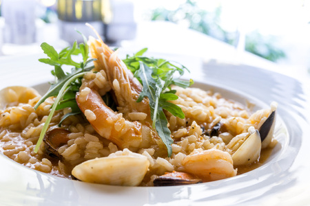 Tasty risotto with Shrimp, fresh herbs vegetables on a white plateの写真素材