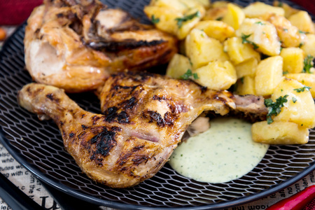 roast chicken with sauce and golden French fries potatoes の写真素材