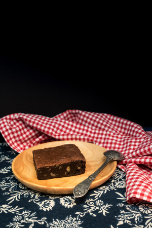 Chocolate Brownie cake on a dark plateの写真素材