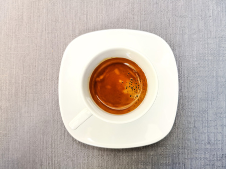 white cup of hot coffee on tableの写真素材