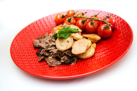 juicy steak veal beef meat with tomato and potatoesの写真素材