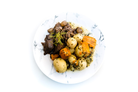 Beef meat stewed with potatoes-Traditional French cuisine Beef Bourguignon potatoes carrots in persilladeの写真素材