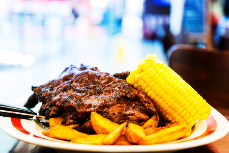 Grilled steak - Grilled meat ribs on the plate with hot sauce の写真素材