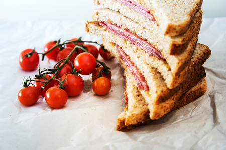 Wholemeal bread sandwich topped with Lyon rosette and butterの写真素材