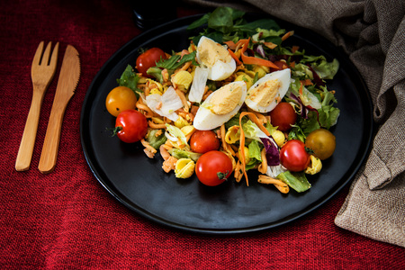 Salad of pasta, egg, smoked salmon tartare, salad and tomato, with a citrus vinaigrette sauce.の写真素材