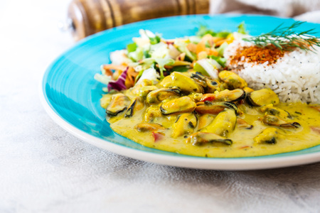 Mussels with curry sauce Rice and saladの写真素材