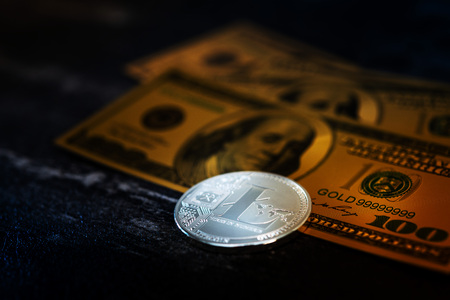 Golden Litecoin and US dollar banknote. Digital cryptocurrency concept