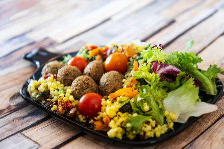 Salad with semolina, Falafels Pickled vegetables and raisins Sauceの写真素材