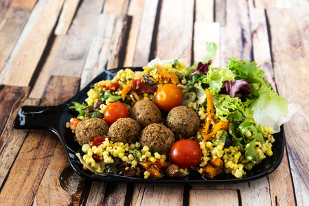 Salad with semolina, Falafels Pickled vegetables and raisins Sauceの写真素材