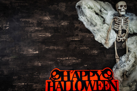Halloween concept with a pumpkin and skeleton on backgroundの写真素材