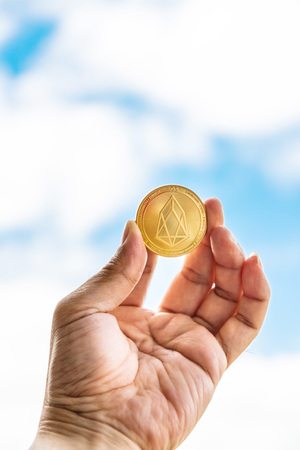 Crypto EOS.IO currency Bitcoin Sky background concept