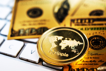 Golden Ripple Coin and US dollar banknote. Digital cryptocurrency conceptの写真素材