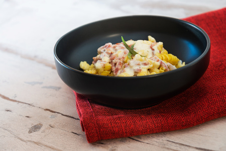 tasty pasta with roast ham on the tableの写真素材