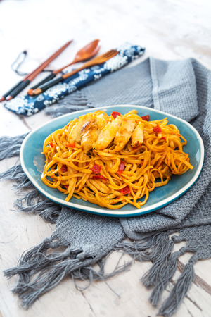 Asian food chicken noodles on the tableの写真素材