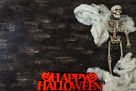Halloween concept with a pumpkin and skeleton on backgroundの写真素材