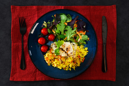 Cooked rice with vegetables, cod and lemon sauceの写真素材