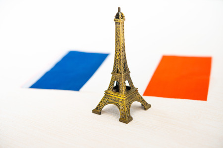 Metal Eiffel Tower and French flag on backgroundの写真素材