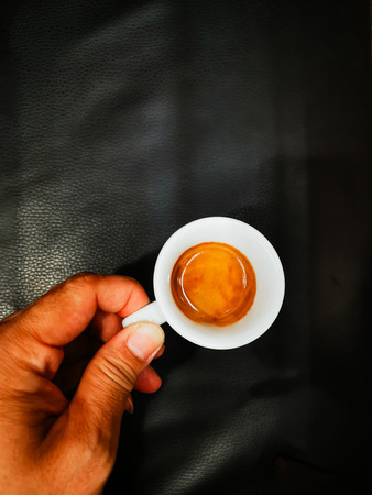 Man holding white cup of hot coffee