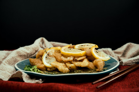 Chinese food fried fish and lemon slicesの写真素材