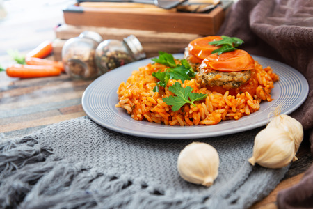 stuffed tomatoes with rice on a white plateの写真素材