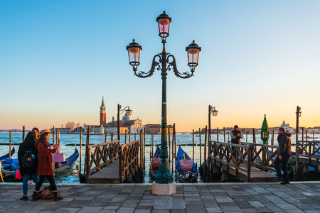 VENICE, ITALY - December 21, 2017 : Tourists foot Street in Venice. its entirety is listed as a World Heritage Site, along with its lagoon. VENICE, ITALY.のeditorial素材