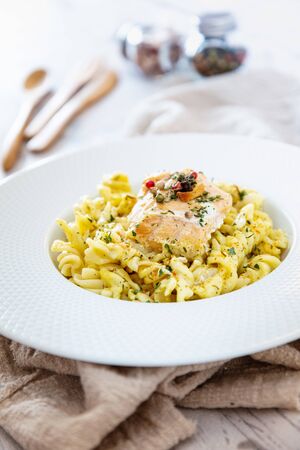 tasty pasta with salmon on a the tableの写真素材