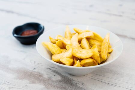 Golden French fries potatoes ready to be eatenの写真素材