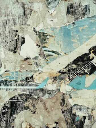 Vintage old posters sticked and torn on wall for your grunge background