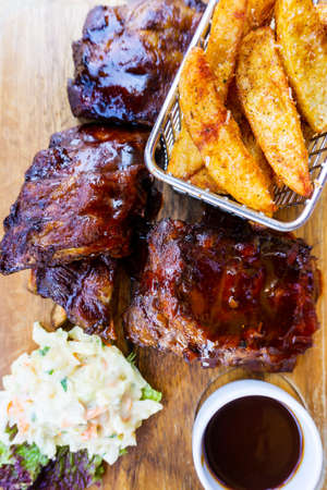 Grilled steak - Grilled meat ribs on the plate with hot sauceの写真素材