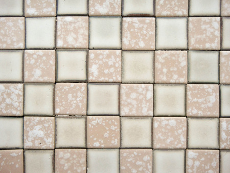 old and pale ceramic tiled floorの写真素材