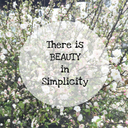nspirational quote " there is beauty in simplicity" on blurred flowers backgroundの写真素材
