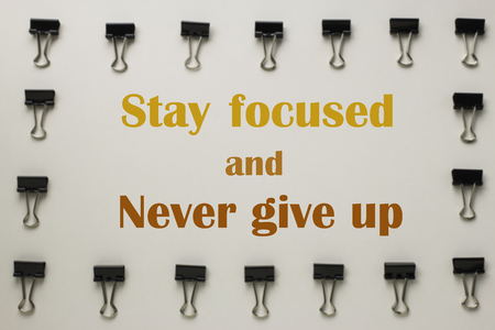 Inspirational quote "Stay focused and never give up" on blurred backgroundの写真素材