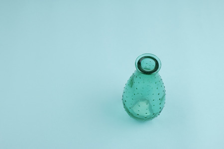 A green vase on blue background.の写真素材