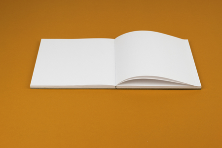 blank notebook on orange background.の写真素材