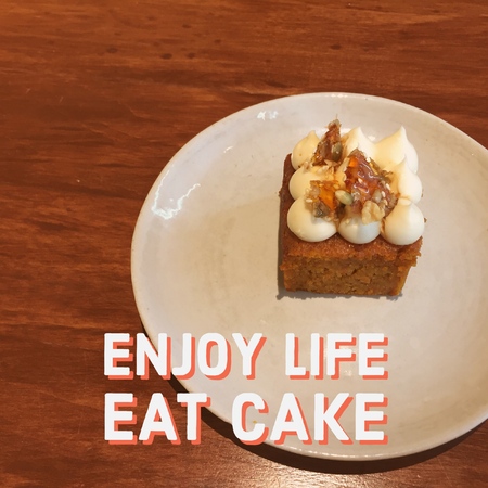 Inspirational Motivational quote Enjoy life eat cake on carrot cake on wooden table background.