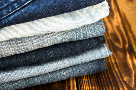 the jeans pile on wooden boardの写真素材