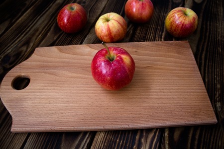 the apples on the wooden boardの写真素材